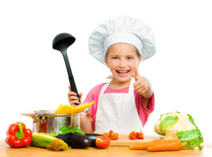 beautiful little girl with spaghetti and vegetables over white