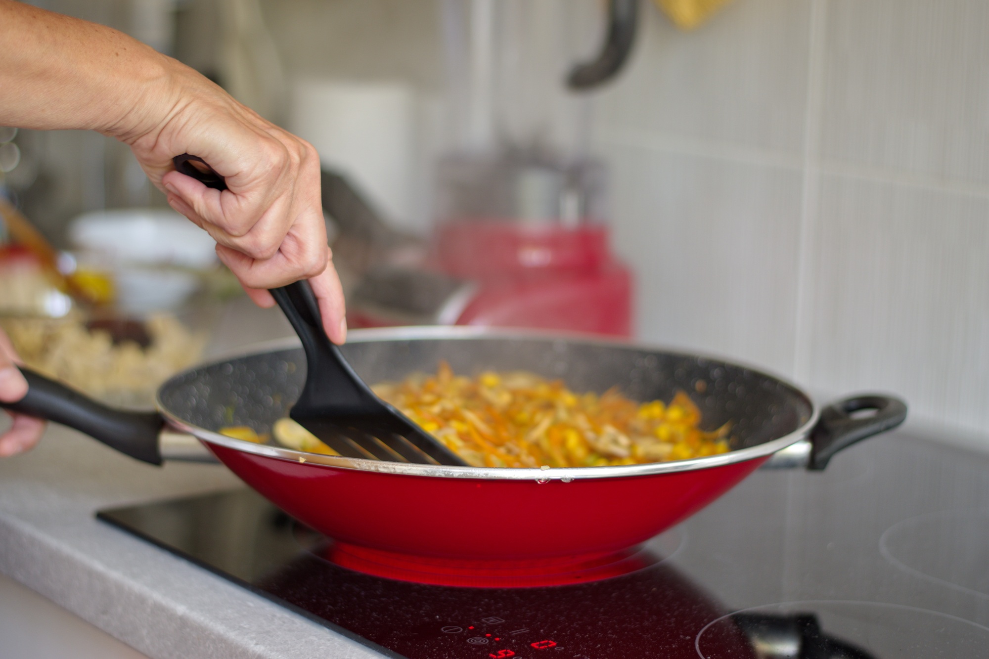 Midsection of woman cooking on the stove